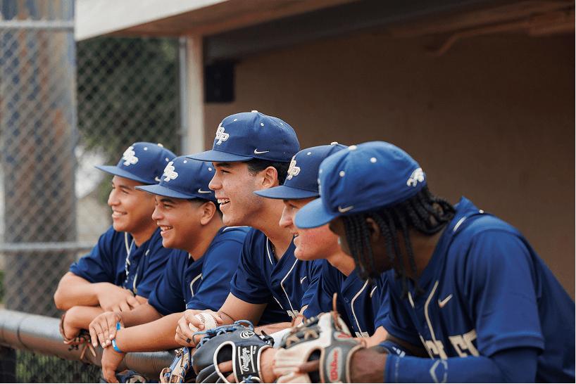 High school baseball players together in a dugout