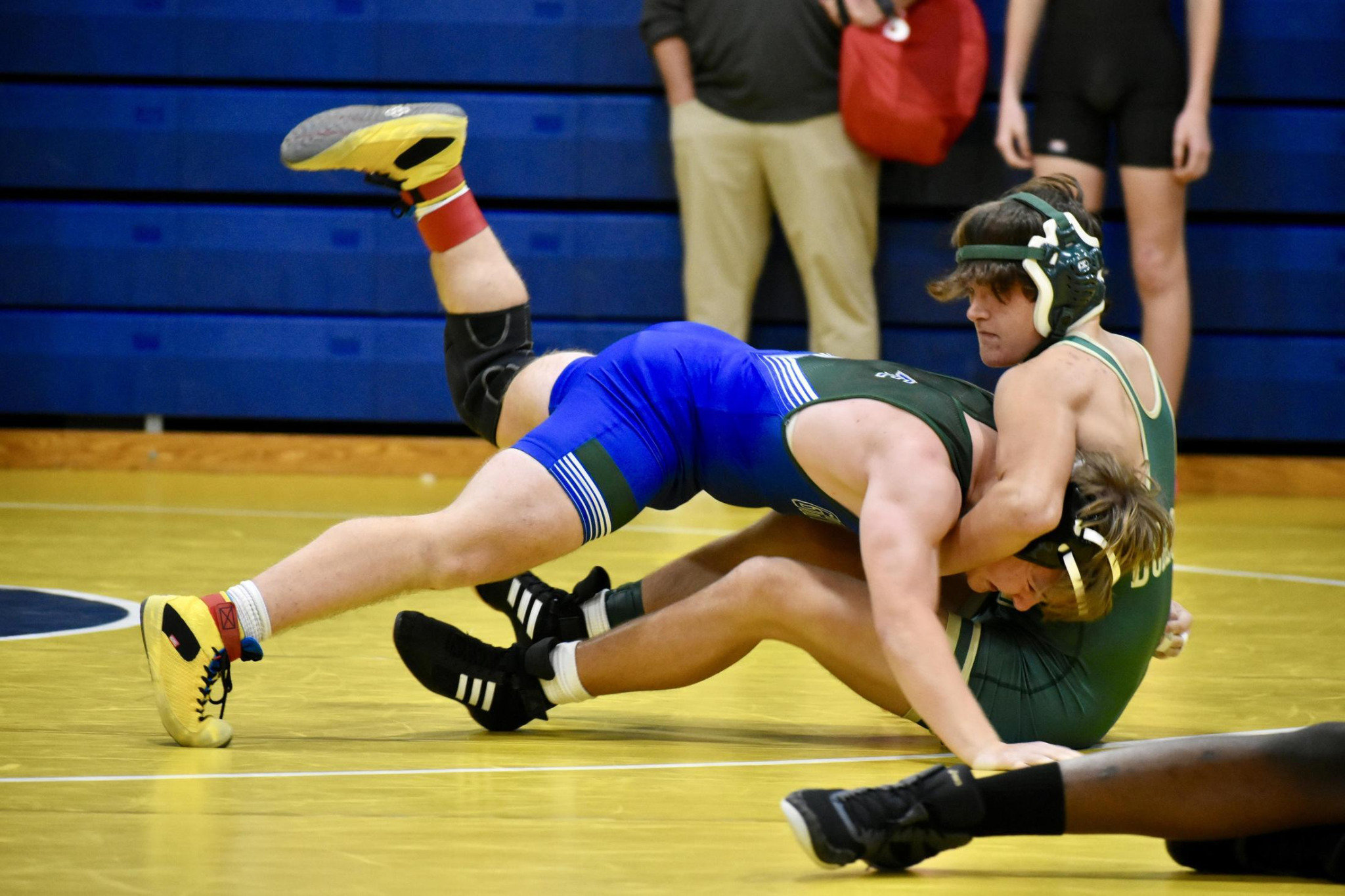 High school wrestlers competing in a gym